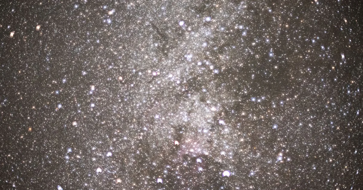 Una vista cautivadora del cielo nocturno que muestra un denso campo de estrellas y galaxias.